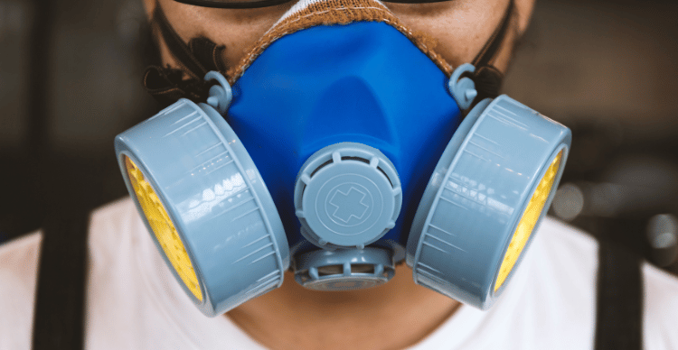 Close-up of a person wearing a respirator with dual filters