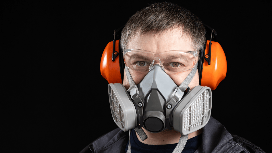 Man wearing a respirator and protective headphones.